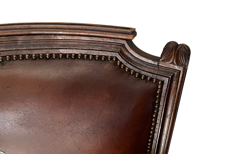 Elegant pair of 20th Century French comfortable worn leather armchairs in the Louis XVI style.