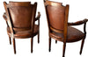 Elegant pair of 20th Century French comfortable worn leather armchairs in the Louis XVI style.