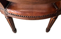 Elegant pair of 20th Century French comfortable worn leather armchairs in the Louis XVI style.