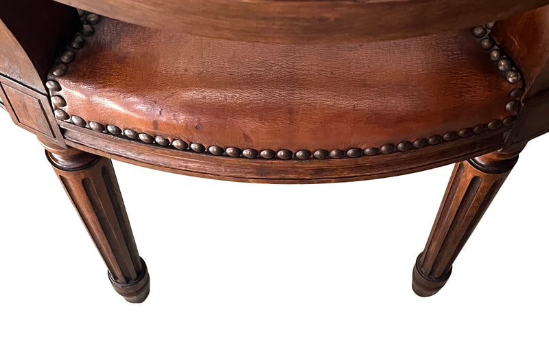 Elegant pair of 20th Century French comfortable worn leather armchairs in the Louis XVI style.