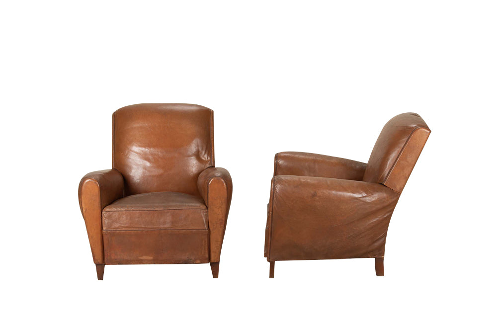 Elegant pair of small leather 20th Century French club chairs.