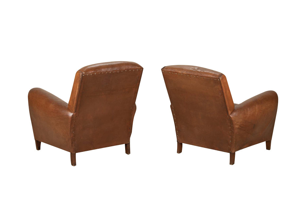 Elegant pair of small leather 20th Century French club chairs.