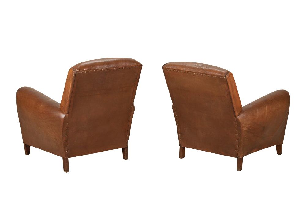 Elegant pair of small leather 20th Century French club chairs.