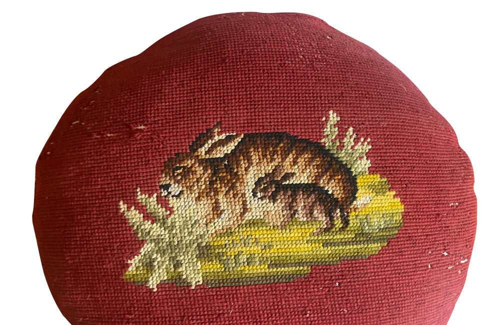 Charming cushion fashioned from a 19th Century French handstitched needlepoint depicting a rabbit and kit.