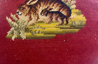 Charming cushion fashioned from a 19th Century French handstitched needlepoint depicting a rabbit and kit.