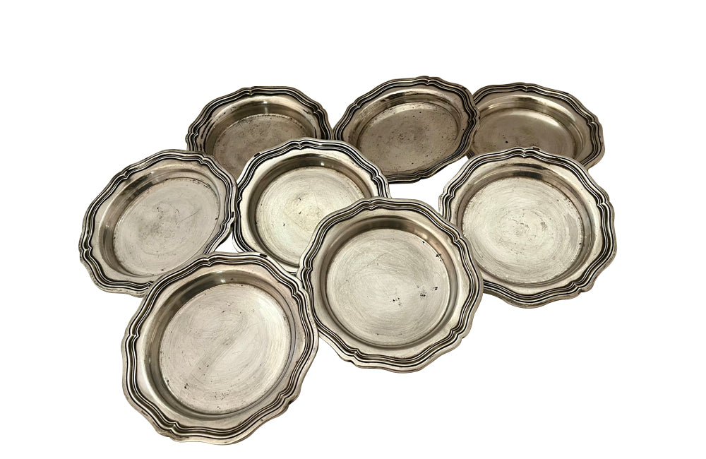 Set of eight antique French nicely worn silverplate coasters.