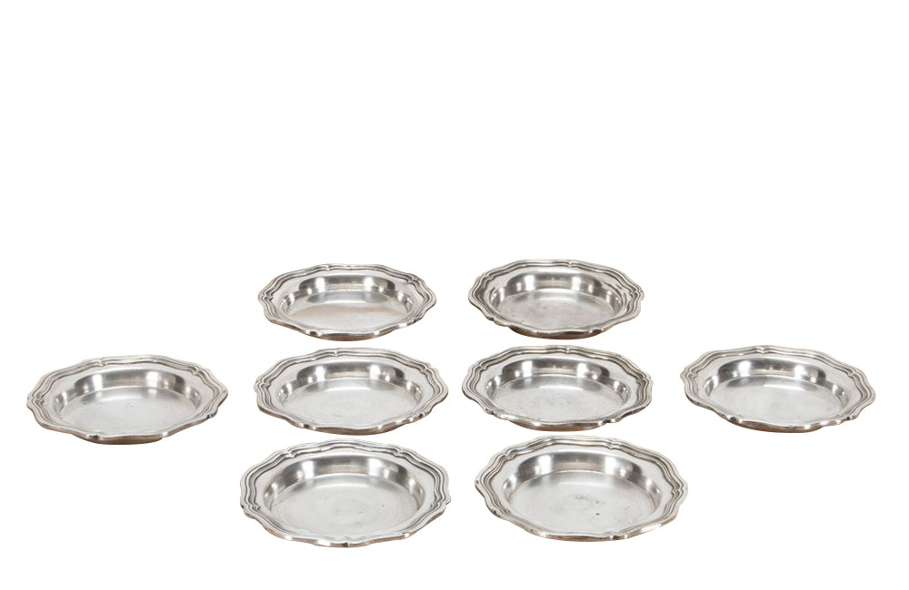 Set of eight antique French nicely worn silverplate coasters.