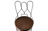 An elegant set of four mid-20th Century French wrought-iron folding chairs of the 'Bouchon de Champagne' type.