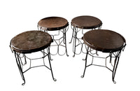 An elegant set of four mid-20th Century French wrought-iron folding chairs of the 'Bouchon de Champagne' type.