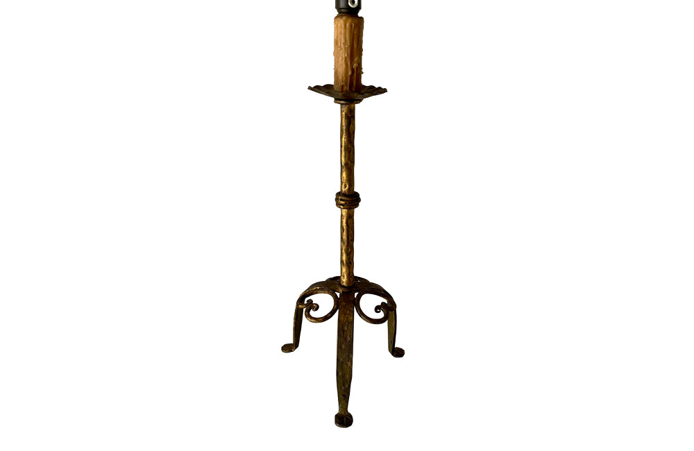 Mid Century Spanish gilt iron table lamp with fluted cup, hammered ringed stem terminating on tripod base with scrolled iron work. 