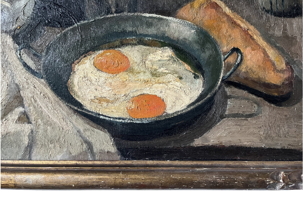 Lovely, French still life painting of fried eggs in a pan, a carafe of water, bottle of wine, glass, loaf of bread, ceramic cup and cloth napkin. 