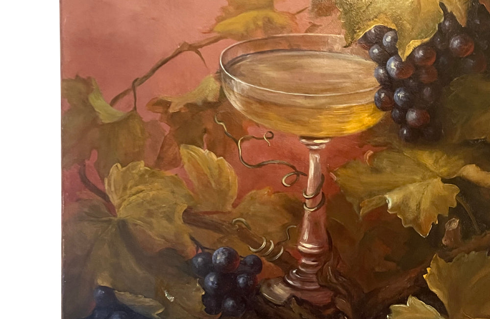 Large French still life painting of grapes and a champagne filled glass coupe.