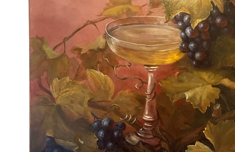 Large French still life painting of grapes and a champagne filled glass coupe.