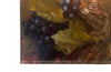 Large French still life painting of grapes and a champagne filled glass coupe.