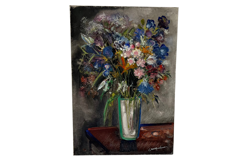 20th Century French unframed oil on canvas painting of a colourful bouquet of wildflowers in a glass vase signed by the artist L. Nuequelman 