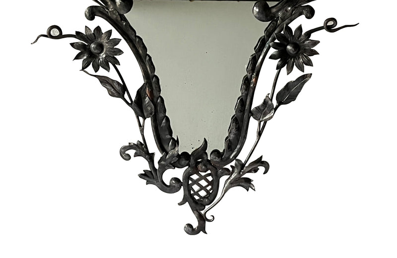 Pretty wrought iron mirror with floral and foliate decoration circa 1900