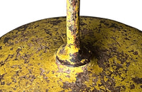 French antique round iron garden table with lovely old yellow paint and three elegant downrights joining to form one stem terminating on a heavy round base