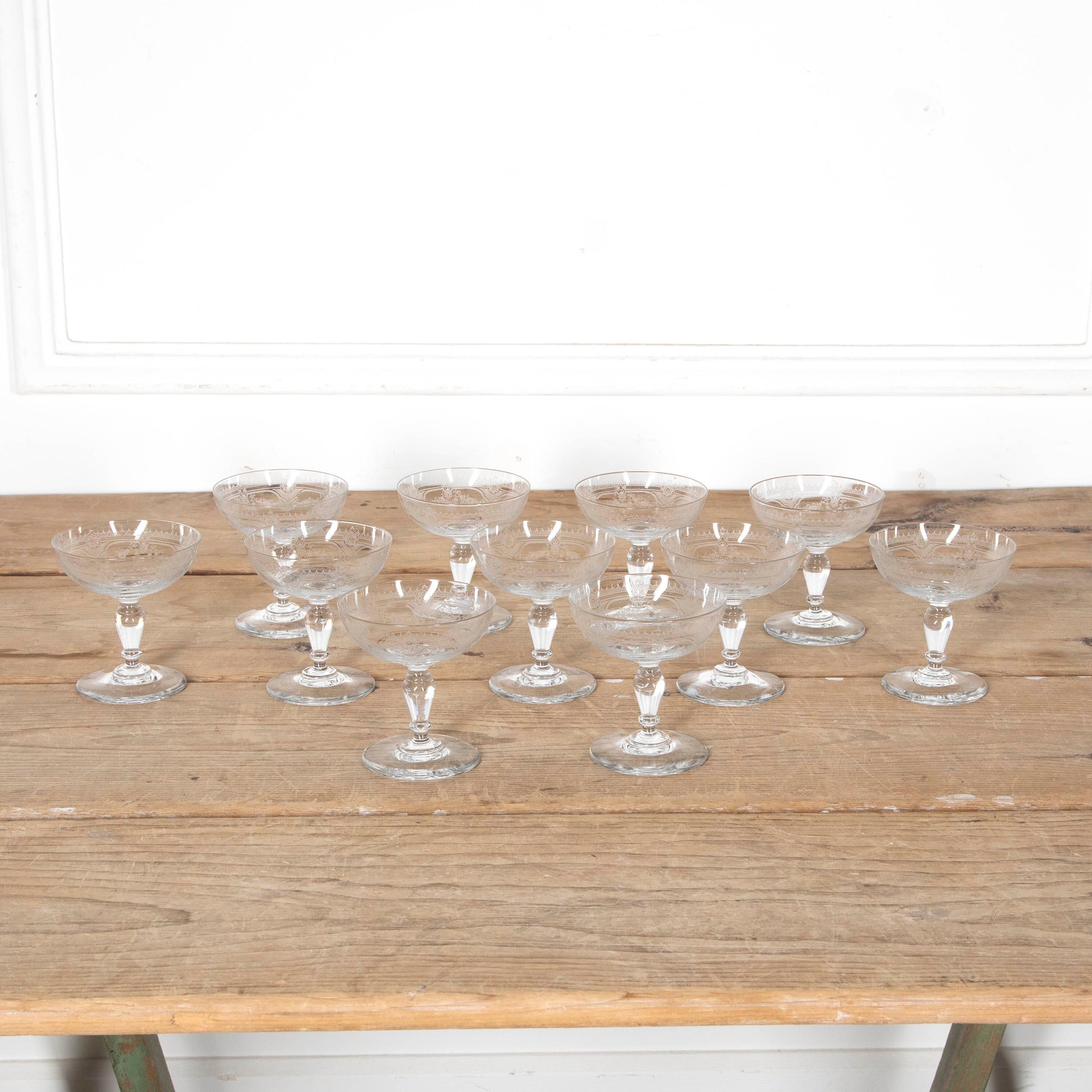 Beautiful set of 11 French champagne coupes decorated with a neo-classical etched design featuring galands of flowers.  c.1900