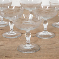 Beautiful set of 11 French champagne coupes decorated with a neo-classical etched design featuring galands of flowers.  c.1900