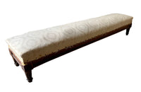 long charming 19th century foot stool has reeded legs and carving to all sides in the Neo-Classical style. 