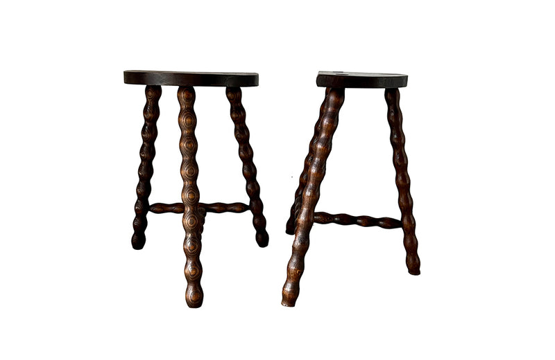 Pair of vintage demi lune tripod stools with bobbin carved legs.