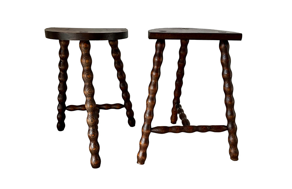 Pair of vintage demi lune tripod stools with bobbin carved legs.