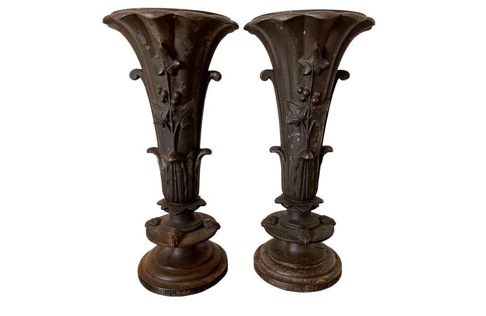 Pair of 19th century French cast iron vases in tulip form with ivy and foliate decoration to both sides. Stamped Bussy.