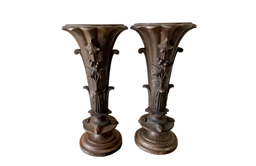 Pair of 19th century French cast iron vases in tulip form with ivy and foliate decoration to both sides. Stamped Bussy.
