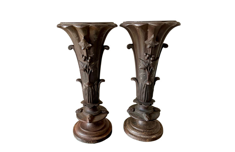 Pair of 19th century French cast iron vases in tulip form with ivy and foliate decoration to both sides. Stamped Bussy.