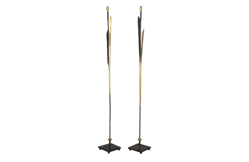 Pair of elegant iron floor lamps in the form of stylised reeds and the stem and square base in black and the leaves gilded.