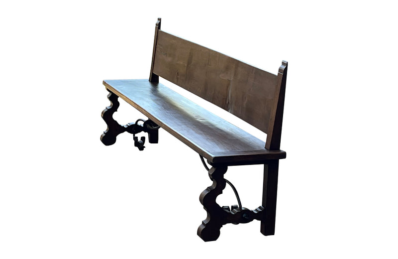 Pair of large Spanish oak benches with backs. Carved legs and decorative wrought iron stretchers. 