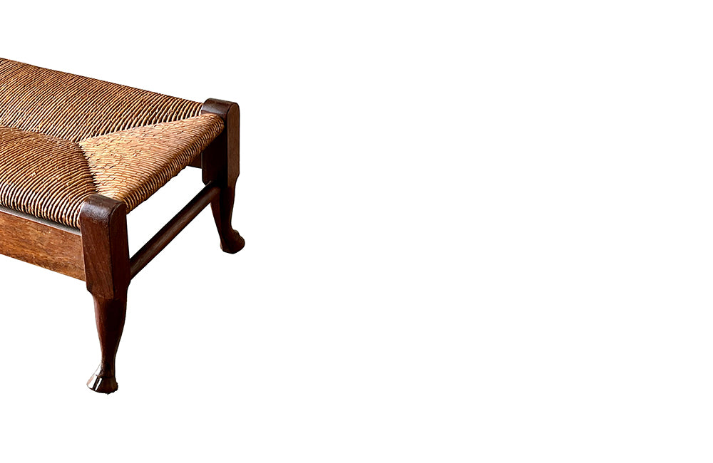 Early 19th century, French walnut strawed chair and its matching footstool , both with carved hooved feet. 