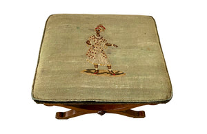 Oak x frame stool in the Neo-Classical style with spindle stretcher its charming tapestry depicting a Caribbean female figure. 19th century