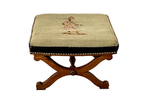 Oak x frame stool in the Neo-Classical style with spindle stretcher its charming tapestry depicting a Caribbean female figure. 19th century