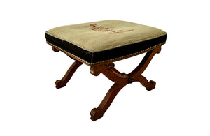 Oak x frame stool in the Neo-Classical style with spindle stretcher its charming tapestry depicting a Caribbean female figure. 19th century