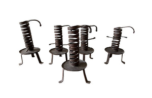 COLLECTION OF FIVE FRENCH IRON CELLAR CANDLESTICKS
