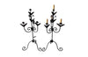 Pair of large wrought iron candle holders from a chateau in the Dordorgne. Tall decorative candlesticks with floral and foliate decoration and have 4 candle holders.